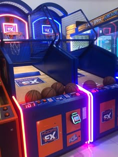 several basketball machines with neon lights on them