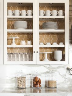 the cabinets in this kitchen are filled with dishes