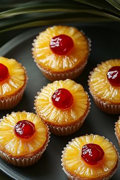 pineapple cupcakes with cherry topping on a plate