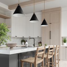 a kitchen with an island and bar stools next to the counter top that has plants on it