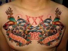 a man with tattoos on his chest has two crossed swords and banners around the chest