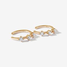 Stay elegant in these ear cuffs. Lazio's sleek design, with triple round cut crystal detailing, makes them the type of earrings to be remembered. Created with a sterling silver base and utilizing luxury 14 karat gold plating, these Adorn Luxe earrings are everything you love about our collection, but with a ‘demi-fine’ jewelry finish. Elegant Adjustable Metal Huggie Earrings, Elegant Adjustable Huggie Earrings For Anniversary, Elegant Adjustable Tarnish Resistant Cartilage Earrings, Adjustable Gold Cartilage Earrings In Cubic Zirconia, Gold Sterling Silver Ear Cuff For Party, Elegant Adjustable Tarnish-resistant Cartilage Earrings, Elegant Adjustable Gold-plated Ear Cuff, Adjustable Metal Ear Climbers In Elegant Style, Elegant Adjustable Gold Plated Ear Cuff