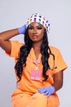 a woman in an orange shirt and blue gloves is sitting on a chair with her hands behind her head