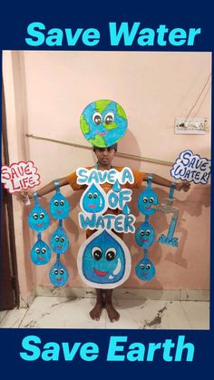 a child wearing a hat and holding up a sign with water on it that says save water