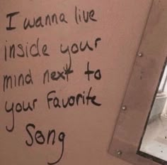 a bathroom wall with writing on it and a mirror in the corner that says, i wanna live inside your mind next to your favorite song