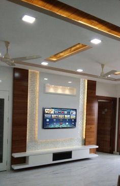 a living room with a flat screen tv mounted on the wall