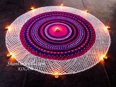 a round doily with lights on it and a red candle in the center is surrounded by white crochet