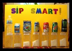 a sign that says sip smart with six cans of soda in front of it on a table