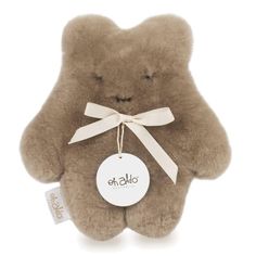 a brown teddy bear with a tag on it's chest