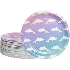 a stack of paper plates with white dolphins on them in pastel blue and pink