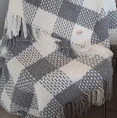 a plaid blanket sitting on top of a chair