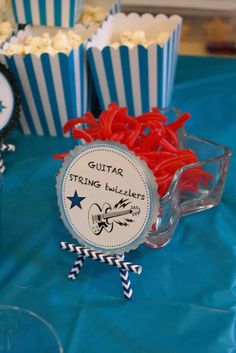 there are some red and blue candy sticks in the cupcakes on the table