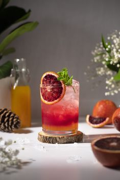 a grapefruit cocktail is garnished with mint