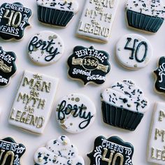 many decorated cookies are displayed on a white tablecloth with black and gold lettering that reads, happy fortyth birthday