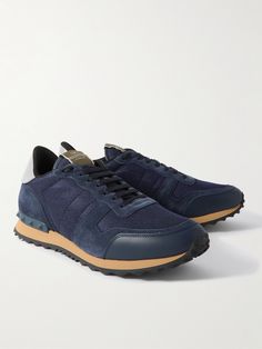 In a neutral navy and grey colourway, Valentino Garavani's 'Rockrunner' sneakers are made from a combination of suede, leather and mesh. They're grounded by gripped soles with tonal rubber studs around the heels. Sporty Navy Suede Sneakers, Blue Leather Sneakers For Running Errands, Sporty Navy Sneakers With Leather Sole, Valentino Garavani Sneakers, Valentino Garavani Shoes, Mesh Sneakers, Summer Sunglasses, Knit Sneakers, Sneakers For Men