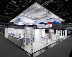 an exhibition stand with white and blue accents