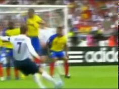 the soccer players are competing for the ball in front of the referee's box