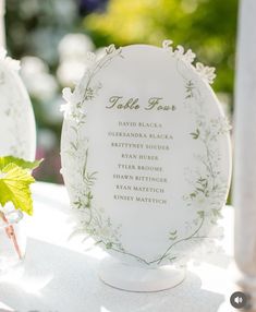 a table with a white plate and flowers on it