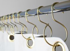 some gold rings hang on the curtain rod