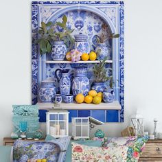 a blue and white room with lemons, vases and other items on the shelves