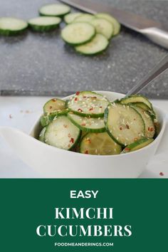 a white bowl filled with sliced cucumbers on top of a counter next to a knife