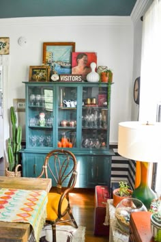 a dining room table with chairs and a china cabinet