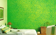 a bedroom with green walls and white bedding in front of a painting on the wall