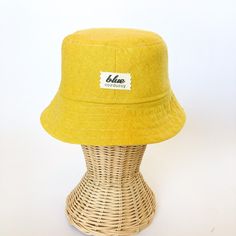 This yellow bucket hat is the perfect thing for babies toddlers and kids on sunny summer days! Washable linen and cotton fabirc makes it an easy go to for at the park, the beach, or even the backyard! This hat will protect delicate skin from the sun and will quickly become a favorite accessory! I made this sun hat from a bold yellow colored linen/cotton blend fabric. The strap closes with snaps under the chin keeps them from pulling it off. Brim measures approx. 2.25 inches. SIZES AVAILABLE 0-3 mos. - fits 14" to 16" head circumference 3-6 mos. - fits 15" to 17" head circumference 6-12 mos. - fits 16" to 18" head circumference 12-24 mos. - fits 17.5" to 19.5" head circumference Small (3 to 5 yrs) - fits 19" to 21" head circumference OVERVIEW + Sewn by me + Yellow Linen and Cotton blend Fab Playful Cotton Bucket Hat With Short Brim, Cotton Bucket Sun Hat For Summer, Yellow Sun Hats For Spring, Yellow Cotton Summer Bucket Hat, Yellow Summer Cotton Bucket Hat, Casual Yellow Cotton Bucket Hat, Cotton Bucket Sun Hat For The Beach, Yellow Cotton Sun Hat, One Size Fits Most, Playful Cotton Bucket Hat For Vacation