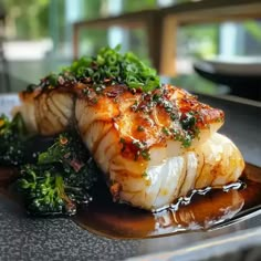 seared scallops on a plate with broccoli and sauce