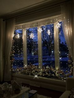 a living room filled with lots of windows covered in christmas lights