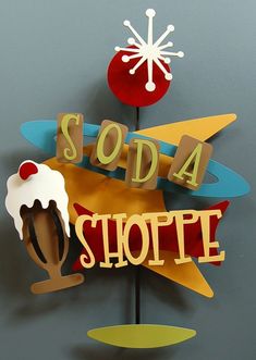 there is a sign that says soda shoppe with an ice cream sundae on it