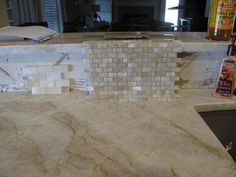 a marble counter top with a bottle of wine on it