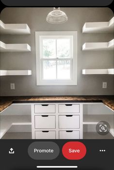 an empty room with shelves and drawers on the wall