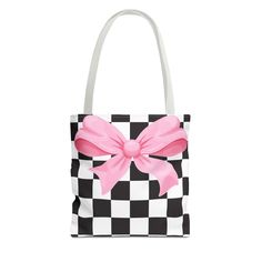 a black and white checkered bag with a pink bow on the front, sitting in front of a white background