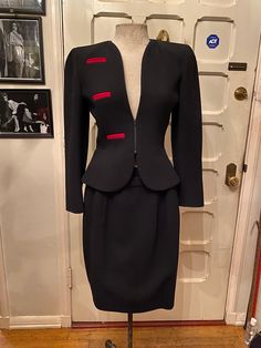 A true work of art. This black skirt suit was made in Italy in the 1980's by Italian designer Valentino. The red trim detailing is insanely chic. There is gorgeous ruche detailing on the shoulders (shown in the 2nd photo).  Mint Condition - This item has been well kept through the years. No tears, stains, or moth holes of any kind.  Dimensions - Size 4. Jacket top - 26 inch waist. 22 inch sleeve. Jacket length from shoulder is 20.5 inches. Skirt bottom - 26 inch waist. 21 inch skirt length. Luxury Fitted Red Skirt Suit, Vintage Black Fitted Skirt Suit, Vintage Fitted Skirt Suit With Notch Lapel, Luxury Vintage Skirt Suit With Buttons, Vintage Single-breasted Long-sleeve Skirt Suit, Valentino Skirt, Black Skirt Suit, Women Suits Wedding, Vintage Valentino