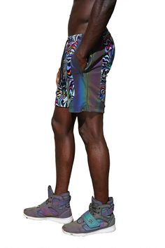 A true kaleidoscope of colors, the Psychedelic shorts are as comfy as they are stylish! Made with quality four way stretchy nylon they are quick drying and perfect for getting down on the dancefloor. The rainbow reflective panels are an added bonus and excellent for glowing in flash photography. Durable, shiny and comfortable a true triple threat! FEATURES: Made with high quality four way stretch holographic multi color neon abstract geometric print spandex Accent side panels made with rainbow r Black Disco Bottoms For Summer, Rave Bottoms With Built-in Shorts, Stretch Rave Bottoms For Streetwear, Iridescent Stretch Bottoms For Summer, Multicolor Athletic Shorts For Streetwear, Sporty Multicolor Nylon Shorts, Fitted Multicolor Nylon Bottoms, Multicolor Stretch Rave Shorts, Multicolor Stretch Bottoms For Pride