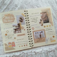 an open notebook with pictures and words on the pages is sitting on a lace tablecloth