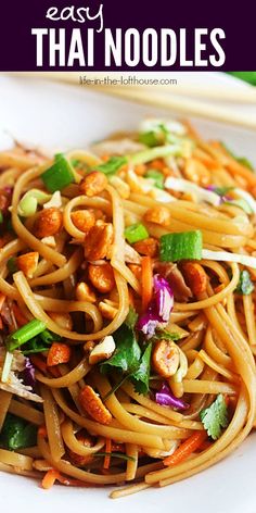 a plate with noodles, carrots and other vegetables on it that are ready to be eaten