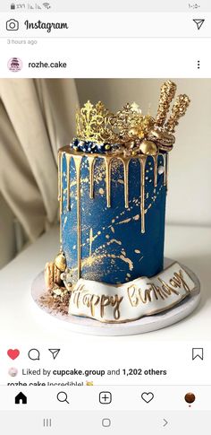 a blue cake with gold decorations on top