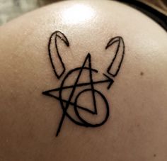 a tattoo on the back of a woman's shoulder that has an inverted triangle and two arrows