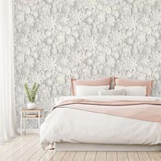 a bedroom with a bed, nightstands and wallpaper in white and pink colors