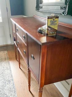 a table with a book on top of it and a mirror in the back ground