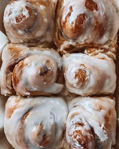 a box filled with glazed donuts covered in icing