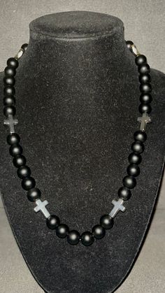 Grab this custom Blackout all Black inspired beaded necklace.  All matte black Beaded Necklace with Silver Crosses!   20in w/ magnetic clasp for easy and comfort. Great for all occassions! Elevate your style AND your game with our vibrant, handcrafted beaded necklace.   Look Good, Feel Good, Feel Good Play Good! BLING BLING ⚾️🏈⚽️🏀⚾️️ 📿 Baseball Football Soccer Softball Basketball 🌟 Features: 🌟 Versatile Wear 🌟 Unique Design 💎 Quality Matters: Thick Elastic band and magnetic clasps ensure durability and long-lasting wear. 📸 Instagram-Ready: Be prepared for compliments and photo ops wherever you go! Follow @DingerCityDrip Black Silver White Cross Beaded Necklace Fruit Loop Phillies Yellow Orange Green Teal Rhinestone Bead Beaded Chain Blue Pink Red Green Baseball Wander Franco Cabrer Spiritual Black Onyx Beaded Necklace, Adjustable Black Beads Cross Necklace, Adjustable Cross Necklace With Black Beads, Black Spiritual Necklaces With Large Beads, Spiritual Black Necklaces With Large Beads, Spiritual Black Necklace With Large Beads, Handmade Black Onyx Beads, Adjustable Cross Necklace With 8mm Beads, Black Onyx 8mm Beads