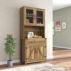 a wooden cabinet sitting in the corner of a room next to a potted plant