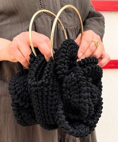 The black crochet bag is a handcrafted yet elegant piece, perfect for completing a casual or boho-chic look. Made from hand-woven cotton or natural fiber yarns, this bag stands out for its unique texture and intricate patterns created by the crochet technique. The black color gives it a timeless sophistication while adding a touch of modernity to its traditional design. It often features sturdy handles and a convenient closure, offering both style and functionality to carry your essentials in st Black Crochet Bag, Bag Stand, Black Crochet, Summer Accessories, Crochet Techniques, Tunisia, Intricate Patterns, Woven Cotton, Traditional Design