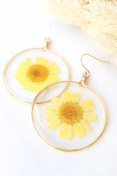 Sunny Daisy is handmade from multiple thin layers of resin and beautiful yellow flowersEarring frames are handmade from tarnish-resistant wire and the hooks are 14k gold plated for additional comfort and longevityPerfectly comfortable and lightweight for all-day useGiven the nature of handmade products and natural variation in flowers, there will be slight variations in each pairEach piece is humbly handmade by L&K in Los Angeles CA :) Size: About 1.5" wide and 2.5" tall (with hooks) Handmade Products, Sunnies, Daisy, Gold Plate, Hoop Earrings, Angeles, Plating, Drop Earrings, Yellow