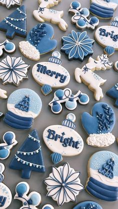 blue and white decorated cookies with merry written on them, all in different shapes and sizes