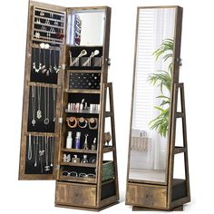 two tall wooden jewelry racks with mirrors on each side and hanging necklaces in the middle