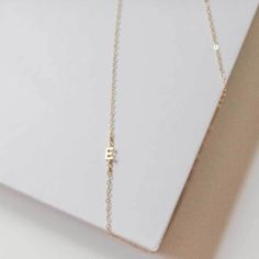 Our Side Initial Necklace is oh-so feminine with its delicate chain, small initial, and special features like the side wire wrap. This necklace chain is 14k gold-filled and can be adorned with up to six initials or birthstones. What a great gift idea for a new mom or a special friend! Pair this initial necklace with our Hammered Initial Ring to show off your creative style. Initial Ring, Delicate Chain, Special Friend, New Mom, Necklace Chain, Wire Wrap, Creative Fashion, Initial Necklace, Wire Wrapped